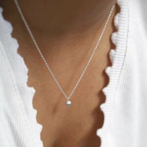 Diamond Shape Necklace on model with white scalloped neckline top