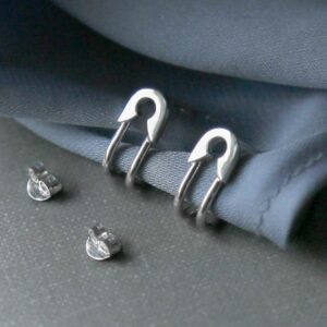 silver safety pin stud bending round wrapped in cloth