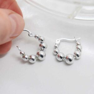 silver balls on hoops held