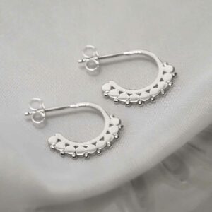 silver confetti on hoop stud earrings on tile