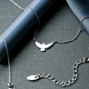 silver bird necklace with chain attached to wings and extension chain