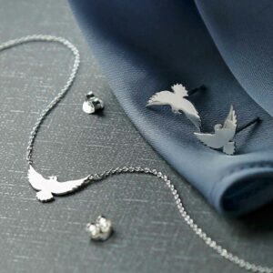 silver bird necklace with chain attached to wings and silver bird stud earrings