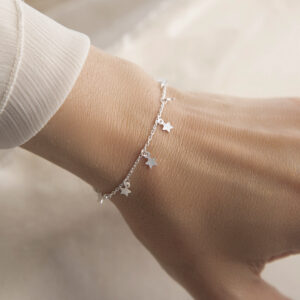 silver tiny stars on chain bracelet on model