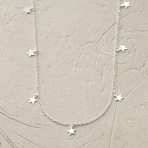 silver tiny stars on chain necklace laid in a loop