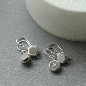 silver plain round dangly earrings and silver engraved round dangly earrings on grey