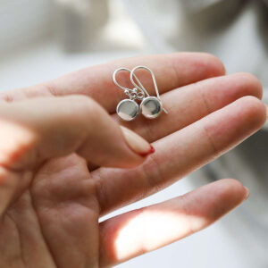 Sterling Silver Engravable Round Dangly Earrings in model hand