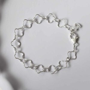 silver clover link bracelet laid in circle