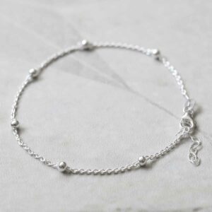 silver chain bracelet with tiny balls laid in circle