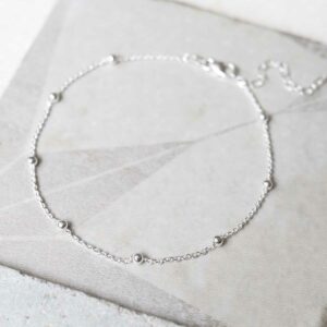 silver chain bracelet with tiny balls laid in circle top view