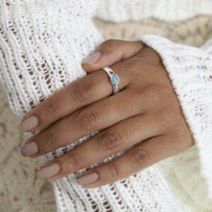 Sterling Silver Turquoise Secret Message Ring on model in white jumper