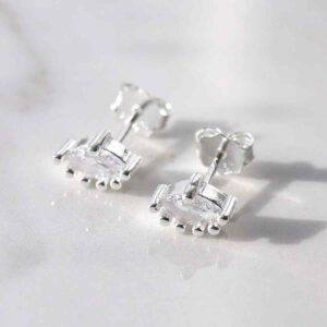 silver eye shaped cubic zirconia set studs on marble tile