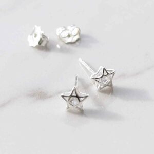 silver star studs with cubic zirconia stone in centre on marble tile taken apart