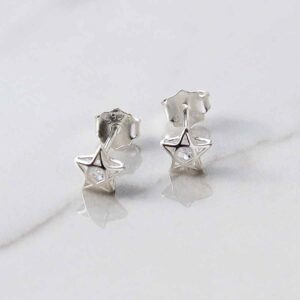 silver star studs with cubic zirconia stone in centre on marble tile