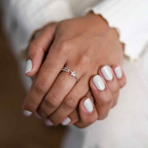 model wearing sterling silver adjustable star ring