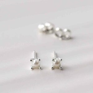 silver tiny basic pearl studs on tile in sunlight