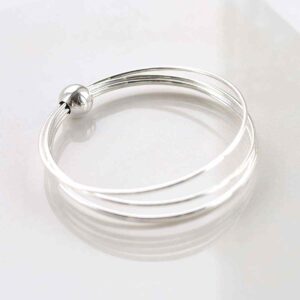 silver bangle with bead on multiple strands design on tile