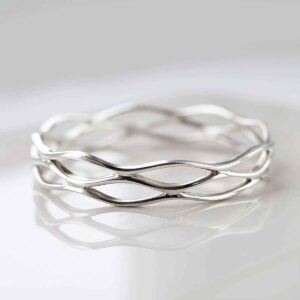 silver lattice net design bangle on white tile