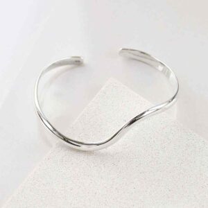 silver wave design cuff bangle on tile