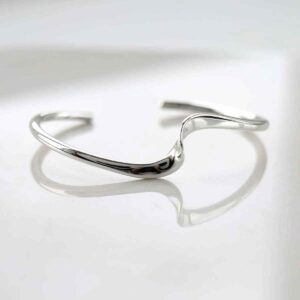 silver twisted ribbon cuff bangle on white tile sunshine