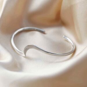 silver twisted ribbon cuff bangle on silk