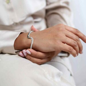 model wearing silver twisted ribbon cuff bangle on wrist