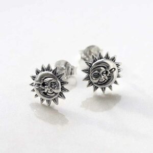 Sterling Silver Sun and Moon Stud Earrings on ceramic background