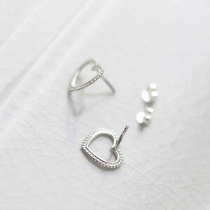 Sterling Silver Beaded Heart Stud Earrings on ceramic background