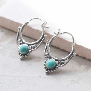 sterling silver turquoise drop hoop earrings ceramic and paint background