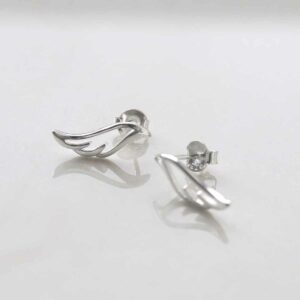 Sterling Silver Hermes Stud Earrings on ceramic background