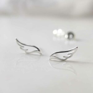 Sterling Silver Hermes Stud Earrings on ceramic background