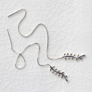 Sterling Silver Fern Threader Earrings on ceramic background