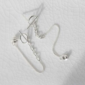 Sterling Silver Circle and Bar Chain Stud Earrings on ceramic background