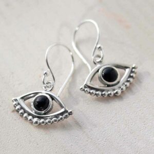 Onyx Evil eye earrings on ceramic background