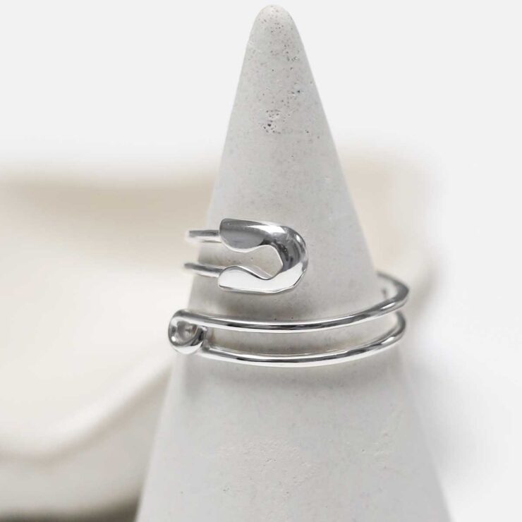 STERLING SILVER ADJUSTABLE SAFETY PIN RING on ring stand