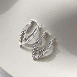 Sterling Silver Beaded Leaf Hoop Earrings on ceramic background