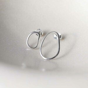 Sterling Silver Asymmetric Oval Stud Earring on ceramic background