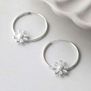 Sterling Silver Daisy Hoop Earrings on ceramic