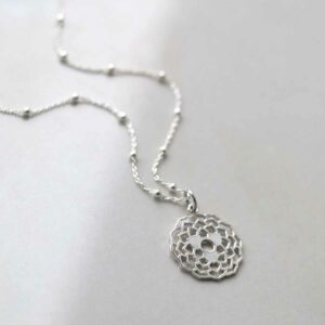 Sterling Silver Dahlia Pendant Necklace on ceramic