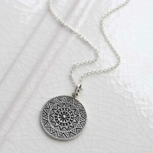 Sterling Silver Aztec Pendant Necklace on ceramic background