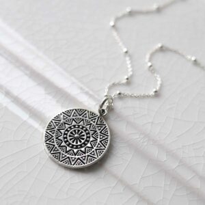 Sterling Silver Aztec Pendant Necklace on ceramic background