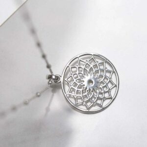 Sterling Silver Mandala Pendant Necklace on ceramic background