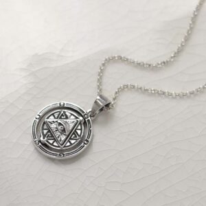 Product photo of sterling silver puzzle pendant on plain background