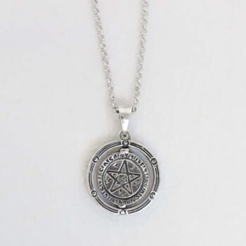 Product photo of sterling silver puzzle pendant on plain background