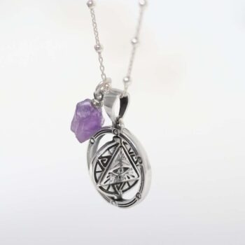 Product photo of sterling silver puzzle pendant on plain background
