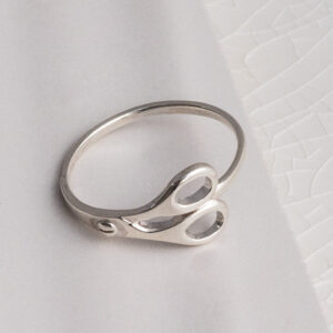 Sterling Silver Scissor Ring on a white tile background.
