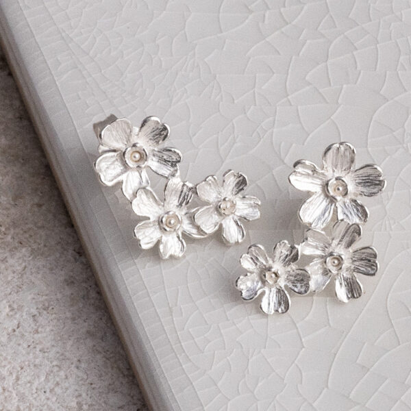 Sterling Silver Triple Flower Studs on a white background.
