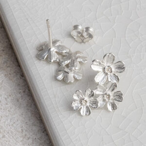 Sterling Silver Triple Flower Studs on a white background.