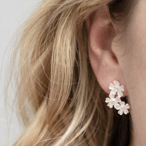 Sterling Silver Triple Flower Studs on a model.
