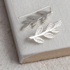 Sterling Silver Leaf Ear Climbers on a white background.