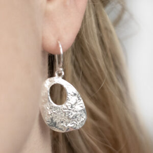 Sterling Silver Molten Dangly Earrings worn by a model.